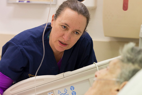Health care worker speaking to a patient. 