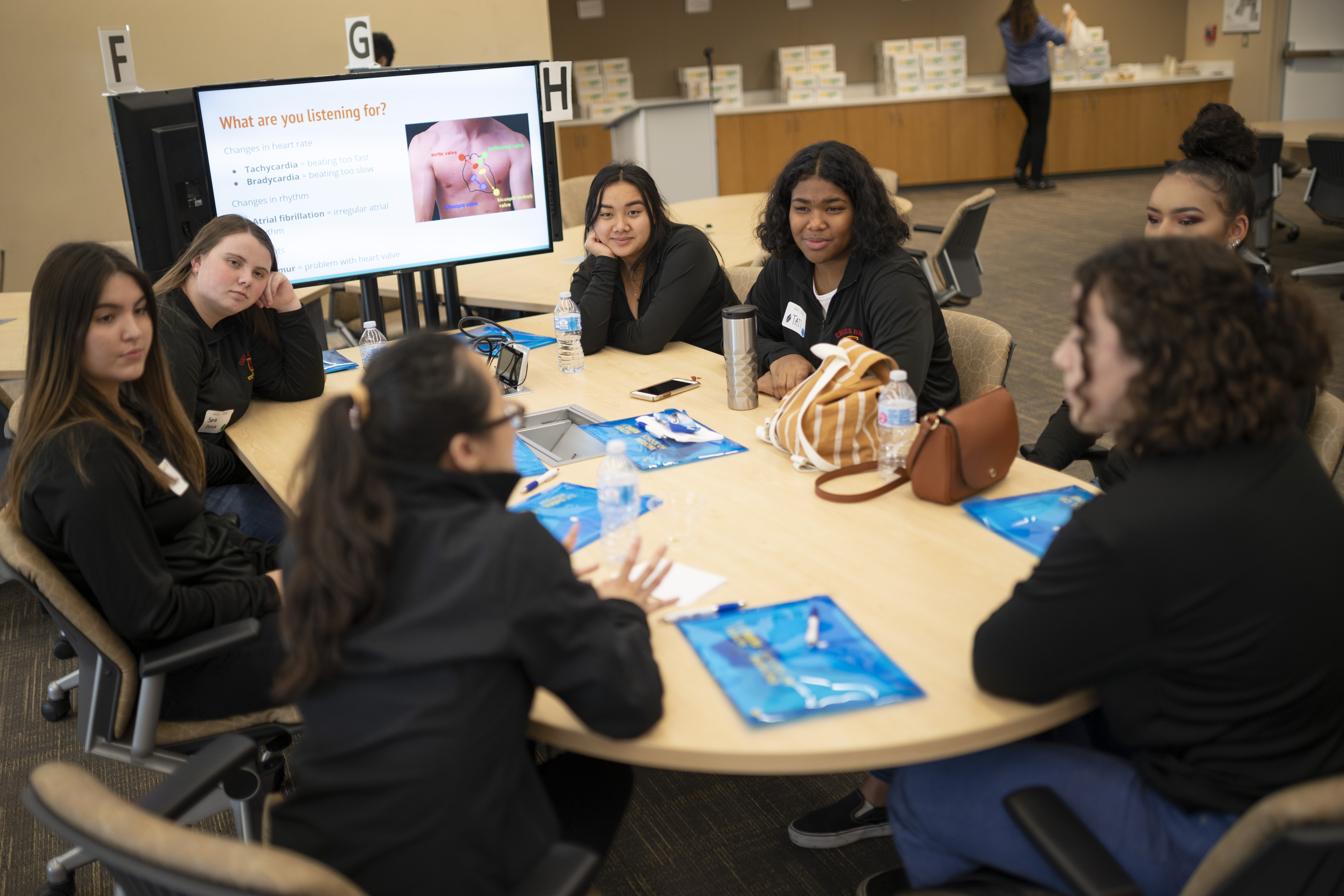 A group of trainees sit together in a conference room.