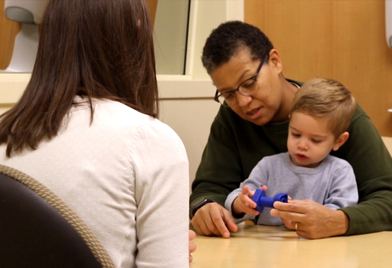 Researcher working with a family