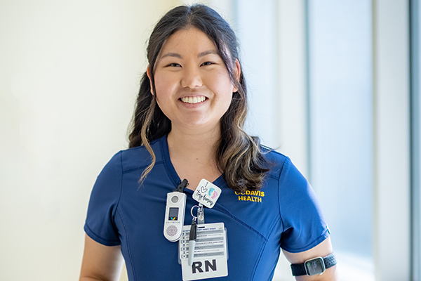 Nurse Ju-A Son prepares an infant bed in the UC Davis Health neonatal intensive care unit.